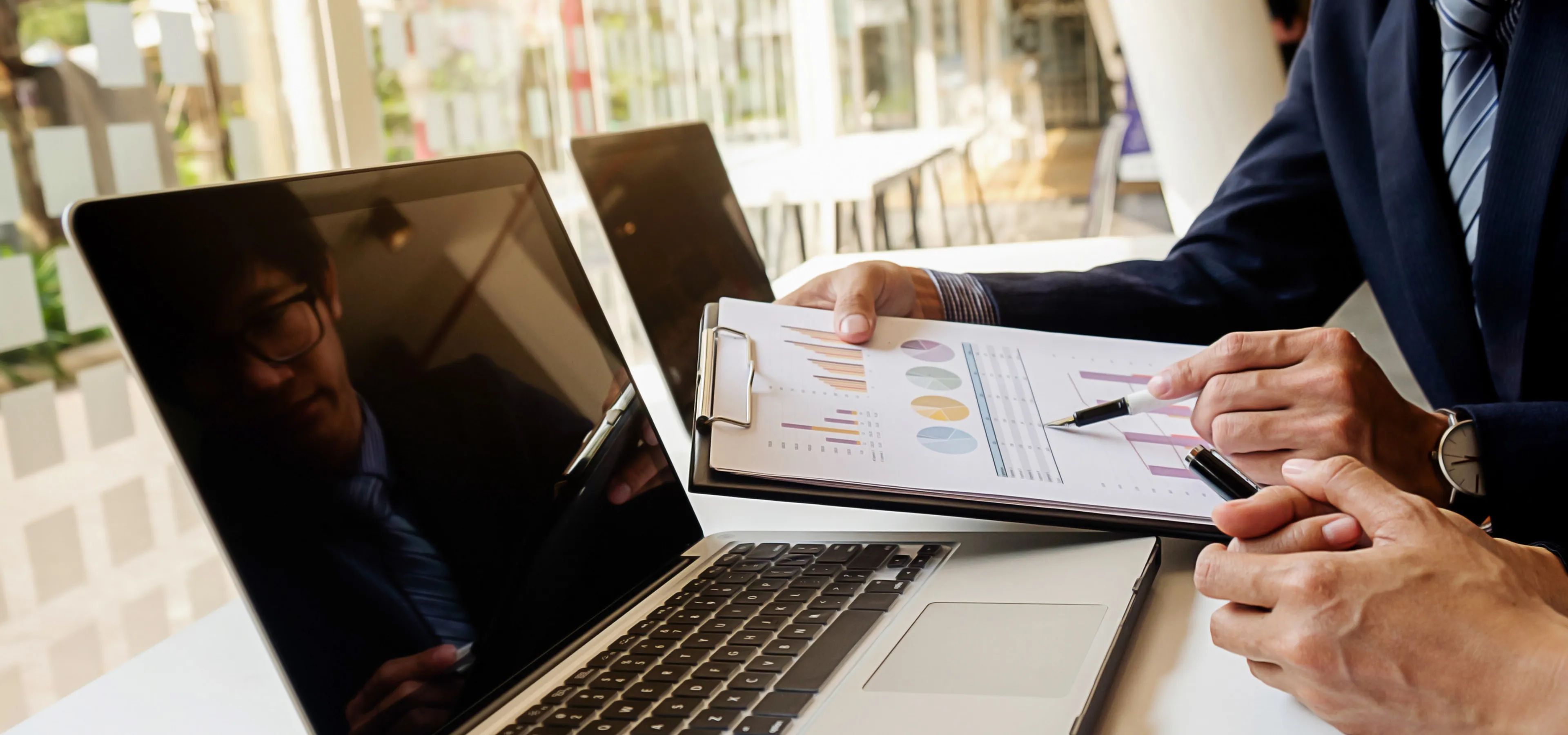 Advisor reviewing financial reports at a desk