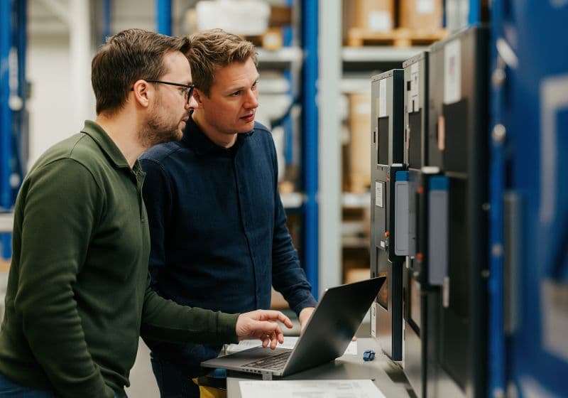 Technicians working together at a workstation