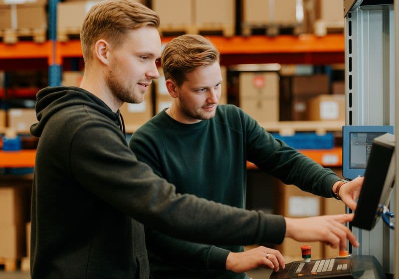 Workers coordinating on the floor of a warehouse